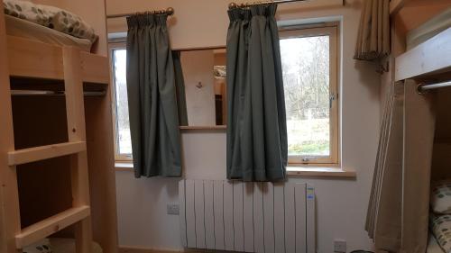 a room with a window and a radiator in a room at Heart of Glencoe Holidays in Glencoe