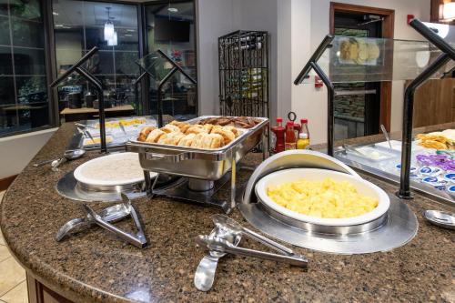 a kitchen counter with a buffet of food on it at Staybridge Suites North Charleston by IHG in Charleston