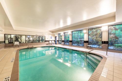 a large swimming pool in a building with windows at Staybridge Suites North Charleston by IHG in Charleston