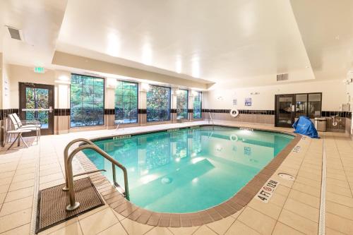 a large swimming pool in the middle of a building at Staybridge Suites North Charleston by IHG in Charleston
