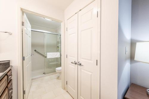 a bathroom with a shower and a toilet at Staybridge Suites North Charleston by IHG in Charleston