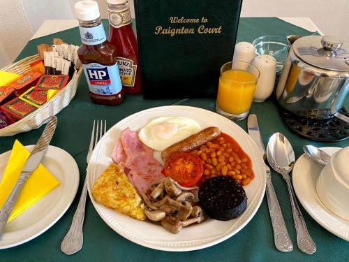 a plate of breakfast food on a table at Paignton Court in Paignton