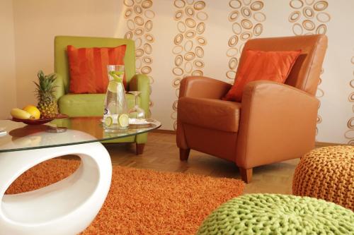 a living room with two chairs and a table at Hotel Wulff in Bad Sassendorf