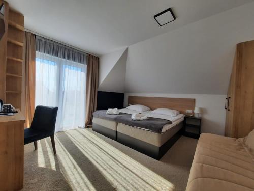 a hotel room with a bed and a window at Pokoje i apartamenty Antonówka in Władysławowo