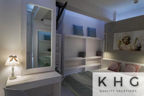 a bedroom with a mirror and a bed in it at KEFALONIA'S HIDDEN GEMS! in Argostoli