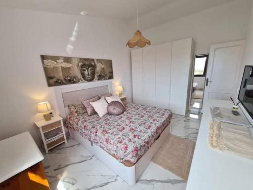 una camera da letto con un letto e un dipinto sul muro di wonderful penthouse with view playa las vistas ad Arona