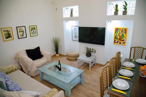 a living room with a couch and a table at Aroura Homes Garden House 2BR 2BA Free Parking in Athens