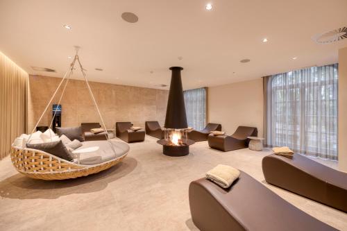 a living room with a hanging couch and chairs at Corsendonk Hooge Heyde in Lichtaart