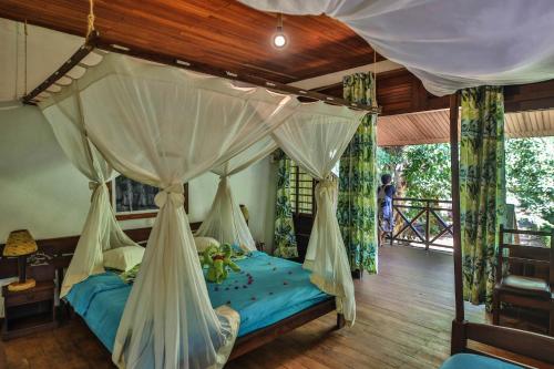 Tempat tidur dalam kamar di OLYMPE DE BEMARAHA