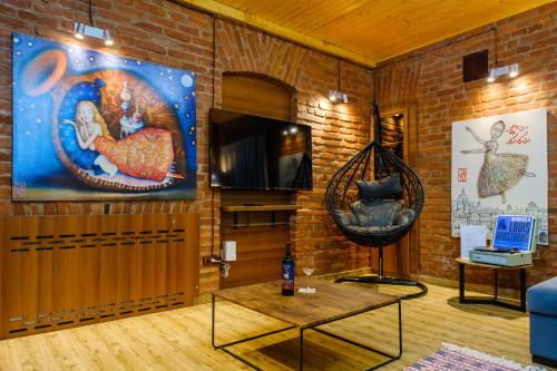 a living room with a brick wall at BB Residence Sololaki in Tbilisi City