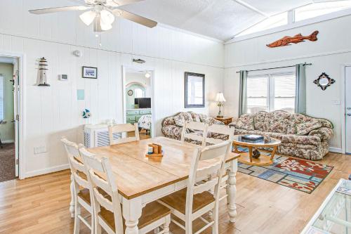 a dining room and living room with a table and chairs at Charisma in Holden Beach