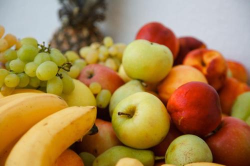 a pile of different types of fruits on a table at Oasis Scaleta Hotel in Skaleta