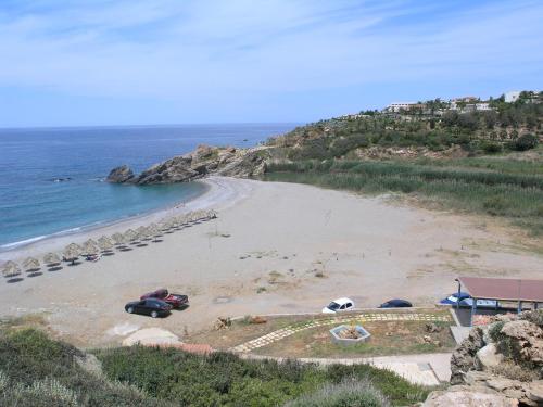 a beach with cars parked on the sand at Oasis Scaleta Hotel in Skaleta