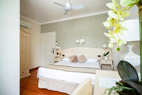 a bedroom with a bed with a teddy bear on it at Hotel Villa Aurora in Lezzeno