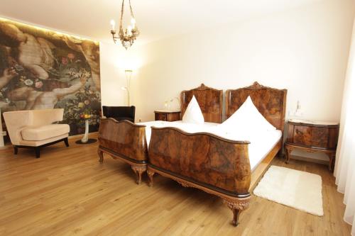 a bedroom with a bed and a painting on the wall at Hotel Wulff in Bad Sassendorf