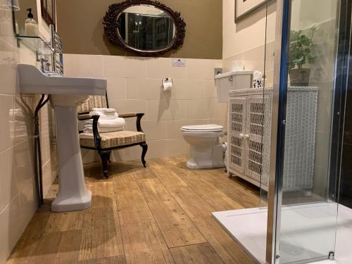 a bathroom with a sink and a toilet and a mirror at Hunters Guest House in Brodick
