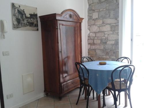a dining room with a table and a wooden cabinet at Villa Giulia in Grado
