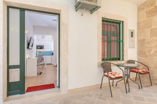 a room with a table and chairs and a kitchen at Stylish studio Dare next to the City walls in Dubrovnik