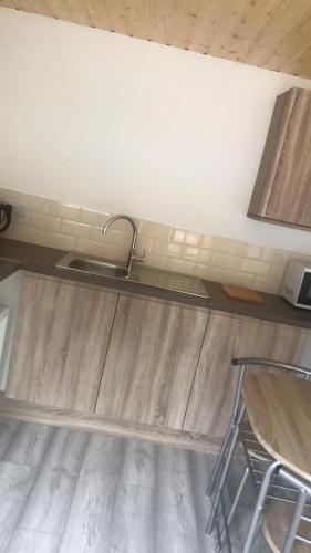 a kitchen with a sink and a counter top at Ardmore Log Cabins in Drumahoe