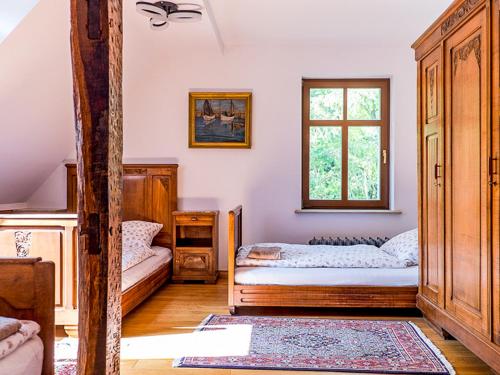 1 dormitorio con 2 camas y ventana en Dwór Gogolewo nad Wartą, en Książ Wielkopolski