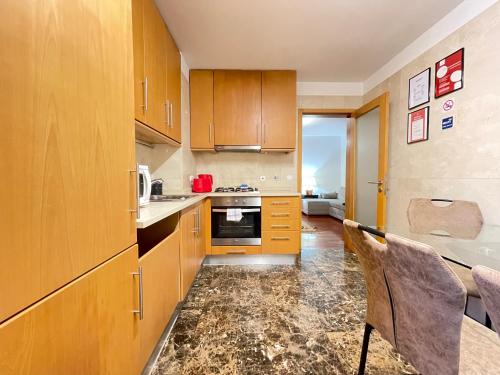 a kitchen with wooden cabinets and a counter top at Miguel Torga Diamond Penthouse in Coimbra