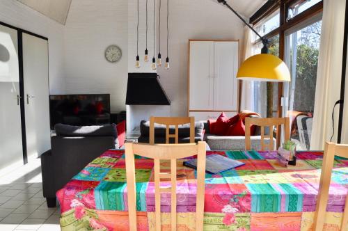a living room with a table and two chairs at Boerenslag 10 in Sint Maartensvlotbrug