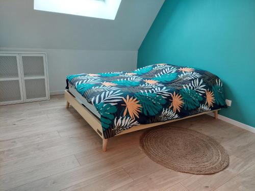 Le gîte du Chat Perché في Cheilly-lès-Maranges: سرير في غرفة ذات جدار ازرق