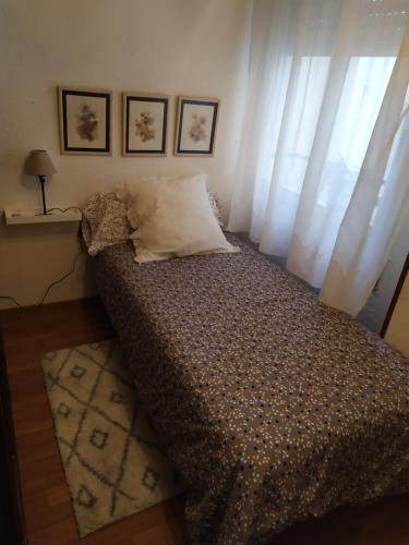 a bedroom with a large bed with a window at Josefa House in Huelva