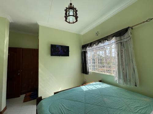 Ένα ή περισσότερα κρεβάτια σε δωμάτιο στο Home Stay Executive Guest House Nairobi