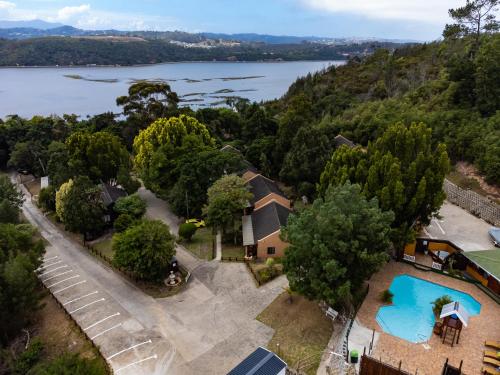 an aerial view of a house with a lake at Gooderson Knysna Chalets in Knysna