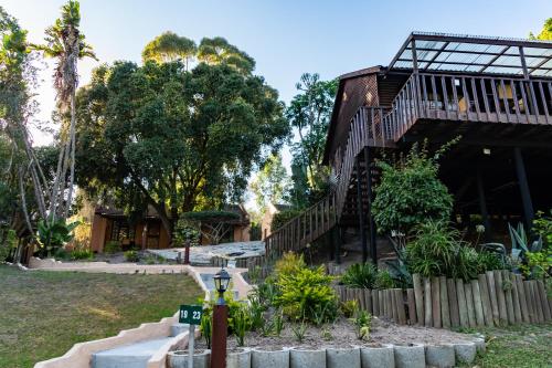 a house with stairs leading up to a building at Gooderson Knysna Chalets in Knysna