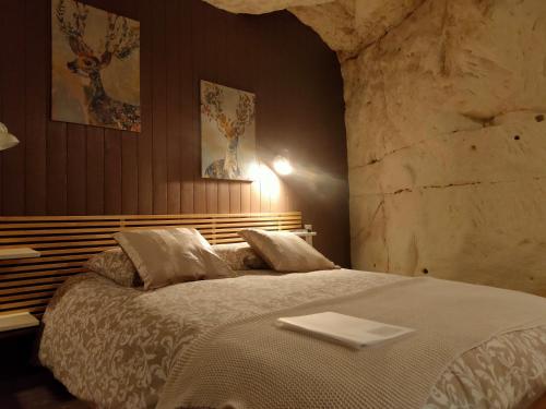 a bedroom with a bed with a tray on it at Les Troglos de Beaulieu in Loches