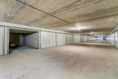 an empty parking lot in an empty parking garage at Kindvriendelijk app met frontaal zeezicht &garage in Koksijde