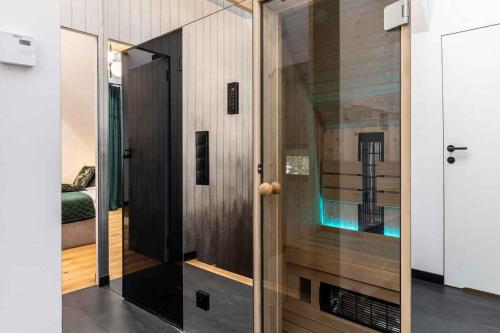 a room with a glass door with a mirror at Mountain Forest in Białka Tatrzanska