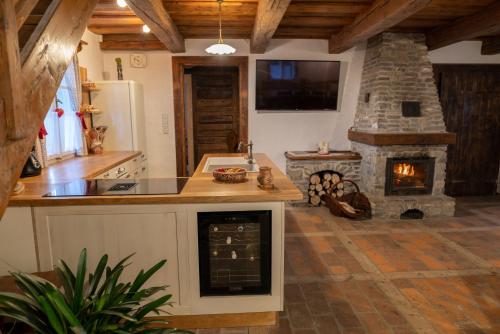a kitchen with a stove and a stone fireplace at Perníkovka in Štramberk