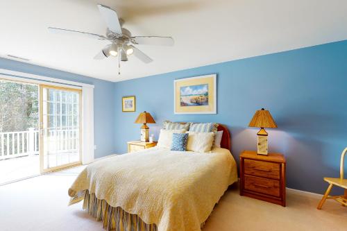 a blue bedroom with a bed and a ceiling fan at Salt Pond -- 13 Skipjack Village in Bethany Beach