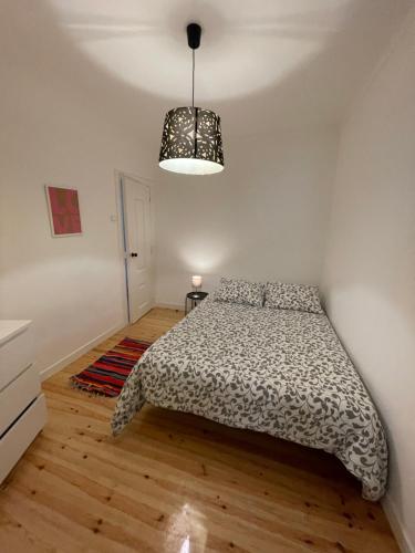 a bedroom with a bed and a pendant light at Beautiful apartment downtown Lisbon in Lisbon
