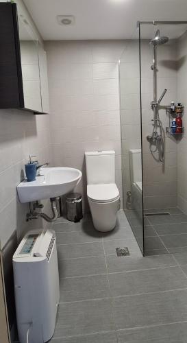 a bathroom with a toilet and a sink and a shower at Folitsa a Lovely central House in Kos