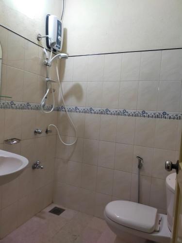 a bathroom with a shower and a toilet and a sink at Lasindu Guest in Ahangama