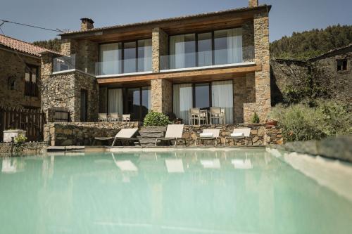 a swimming pool in front of a house at Mountain Whisper in Gondramaz