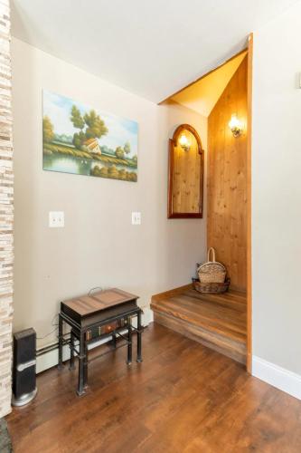 a living room with a bench and a table at Bluebird Manor on the Water, 2 Acres & Amenities in Liberty