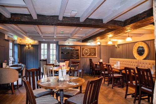 
a dining room filled with tables and chairs at Old Mill Hotel by Greene King Inns in Coventry
