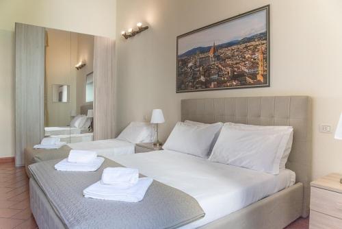 En eller flere senge i et værelse på Coco Places Soggiorno Panerai, Centro Storico