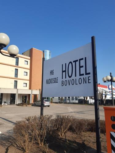 a sign for a hotel in a parking lot at Hotel Nuovo Sole HNS in Bovolone