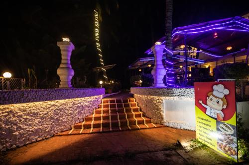 a set of stairs in front of a building with purple lights at The Woodside Inn in Benaulim