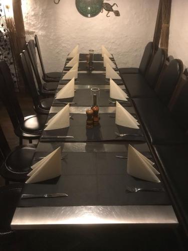 a long black table with white papers on it at Hotel Allegra in Heinsberg