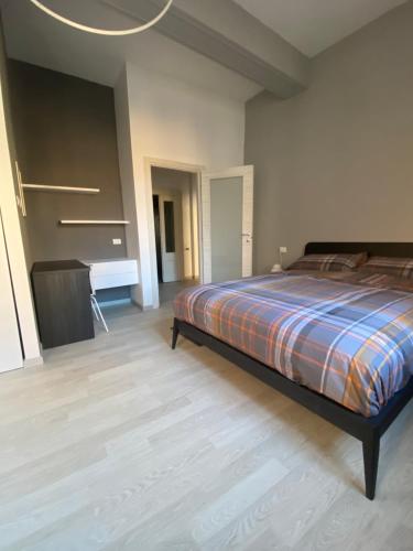 a bedroom with a bed and a desk in it at CasaLonghi in Mantova