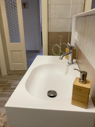 a white sink with a faucet on top of it at CasaLonghi in Mantova