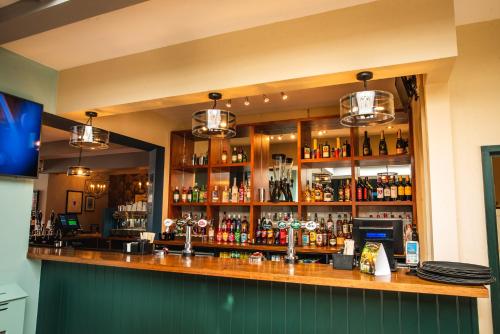 a bar with a lot of bottles of alcohol at The Market House in Glastonbury