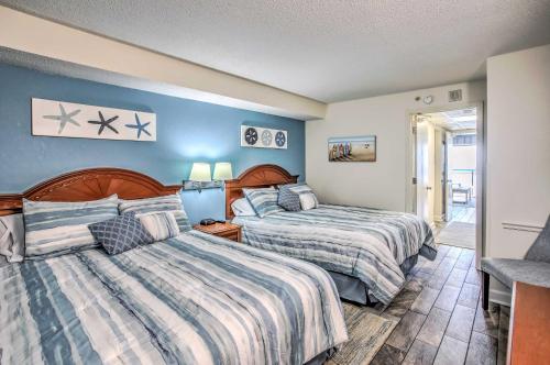 2 Betten in einem Schlafzimmer mit blauen Wänden in der Unterkunft Airy Oceanfront Myrtle Beach Condo with Balcony in Myrtle Beach